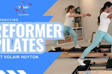 Promotion for reformer Pilates in big highlighted writing blue background and image underlayer of of two people using a reformer.